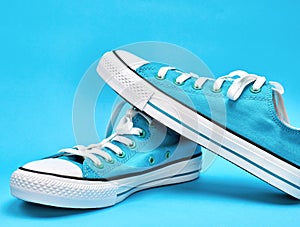 pair of blue textile sneakers with white laces