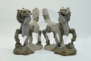 A pair of bronze Chinese Qilin figurines, shown here with 2 horns each and Chinese dragon-like features