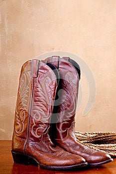 A pair of brown cowboy boots rope photo