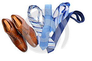 A pair of brown dress shoes with blue neckties on white background