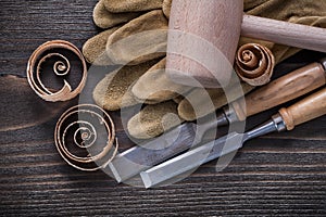 Pair of brown leather gloves firmer chisels wooden hammer and sh