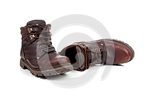 A pair of Brown leather hiking boots on white