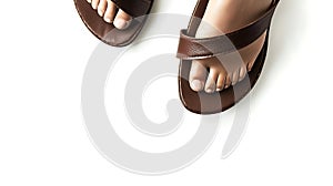 Pair of brown sandals with a brown strap