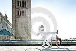 Pair of capoeira performers doing a kicking photo