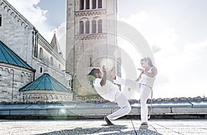 Pair of capoeira performers doing a kicking photo