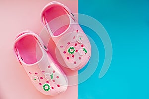Pair of casual comfortable pink summer shoes for kids on pink, blue background,kids shoes for beach, sea and