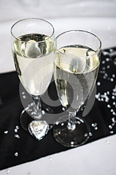 A pair of champagne flute glasses with sparkling drink