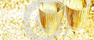 Pair of champagne flutes on shiny background