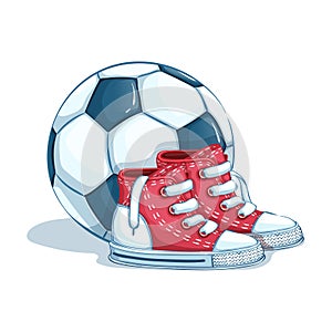 A pair of children`s sports shoes and a soccer ball.