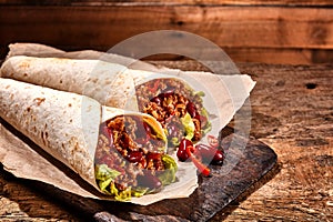 Pair of Chili Stuffed Tex Mex Wraps on Wood Table