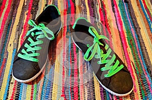 Pair of colorful sneakers laid on the textil floor background