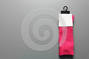 Pair of colorful socks on gray background with space