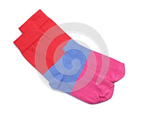 Pair of colorful striped socks on white background, top view