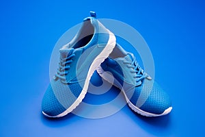 pair of comfortable sport shoes. sporty blue sneakers. shoes on blue background.