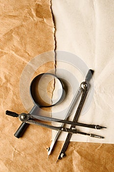 Pair of compasses and magnifying glas