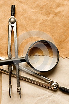 Pair of compasses and magnifying glas