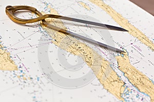 Pair of compasses for navigation on a sea map