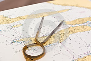 Pair of compasses for navigation on a sea map