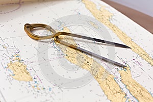 Pair of compasses for navigation on a sea map