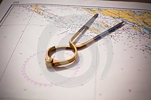 Pair of compasses for navigation on a sea map