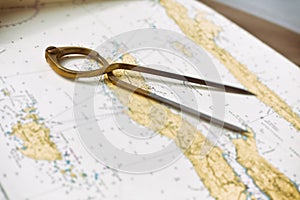 Pair of compasses for navigation on a sea map