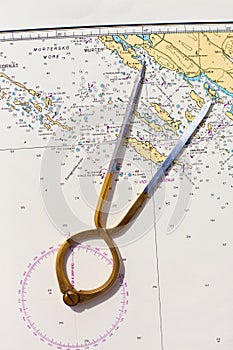 Pair of compasses for navigation on a sea map