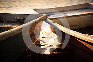 Pair of conjunct boats on a lake during a golden sunset photo