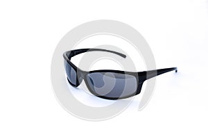 Pair of cool, macho, masculine, black sun glasses, side view on white background