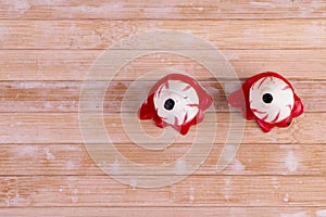 Pair of creepy bloodshot eyes isolated on wooden background