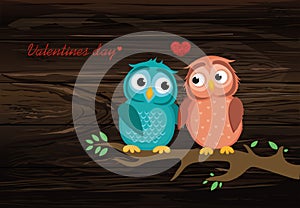 A pair of cute owlet sitting on a branch. Owls in love hearts ar