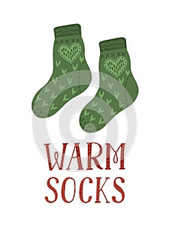 Pair of cute warm wool green socks with lettering `Warm socks`