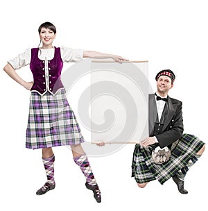 Pair of dancers of Scottish dance with empty banner