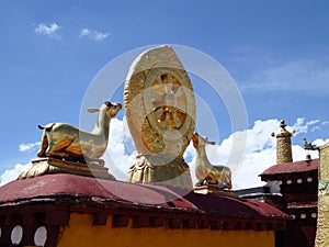 A pair of deer flanking the eight-spoked Dharma wheel on lotus flower, on the roof of Jokhang Monastery, Lhasa, Tibet