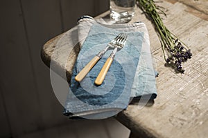 Pair of Dining Forks Over Napkins on Wooden Table