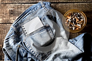 Pair of dirty jeans,notepad and an ashtray