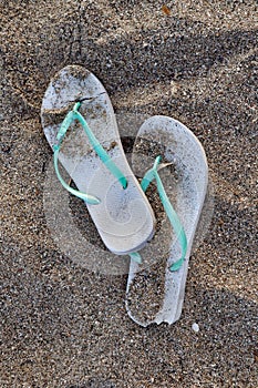 A pair of discarded and split flip flops