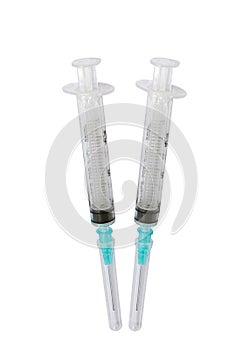 Pair of disposable syringes on white background