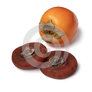 Pair of dried kaki persimmon and a fresh one on white background close up