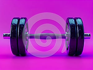 A pair of dumbbells on a purple background photo