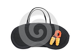 Pair of ear plugs and black sleeping mask on white background, top view