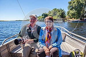 Pair of elderly tourists with cameras