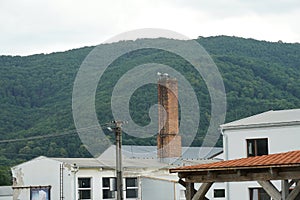 Pair of European white stork on factory chimney of old industrial building