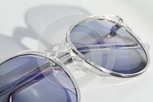 Pair of eye glasses on a white background. Correct optics against ametropia. Spectacles with chameleon and tinted lens