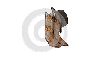 A pair of fancy brown cowboy boots with a brown outback hat