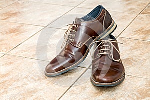 Pair of fashion brown men`s shoes with shoestring