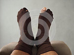 A pair of feet with brown socks
