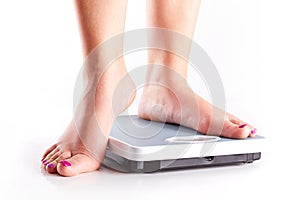 A pair of female feet on a bathroom scale