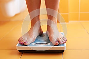 A pair of female feet on a bathroom scale