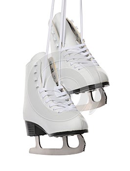 Pair of figure ice skates hanging on white background