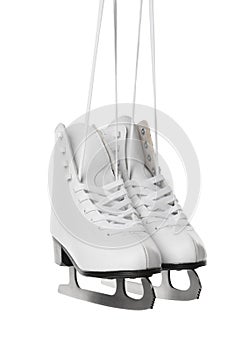 Pair of figure ice skates hanging on white background